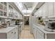 Bright kitchen with white cabinets, vaulted ceilings, and stainless steel appliances at 6114 43Rd W St # 104E, Bradenton, FL 34210