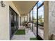 Screened patio with small table and chairs, and lush green landscaping view at 6114 43Rd W St # 104E, Bradenton, FL 34210