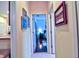 Hallway leading to a bedroom featuring hardwood floors and natural light at 6611 Pinefeather Ct, Bradenton, FL 34203