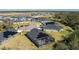 Aerial view of houses with solar panels and a community pool at 6614 162Nd E Pl, Parrish, FL 34219