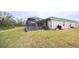 Screened lanai and backyard with grassy area at 6614 162Nd E Pl, Parrish, FL 34219