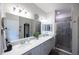 Double vanity bathroom with large shower and modern lighting at 6614 162Nd E Pl, Parrish, FL 34219