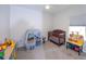 bedroom with crib, toy storage, and workspace at 6614 162Nd E Pl, Parrish, FL 34219