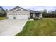 Two-car garage and neatly landscaped front yard at 6614 162Nd E Pl, Parrish, FL 34219