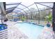 Covered pool and patio area with lounge chairs at 6614 162Nd E Pl, Parrish, FL 34219