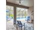 Enclosed pool area with seating and plenty of plants at 6614 162Nd E Pl, Parrish, FL 34219