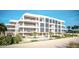 Luxury beachfront building featuring a pool and outdoor space at 70 Avenida Veneccia # 202, Sarasota, FL 34242