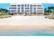 Modern beachfront building with expansive windows and private beach access at 70 Avenida Veneccia # 202, Sarasota, FL 34242