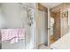 Bathroom featuring glass enclosed shower with modern fixtures, tiled floors and closet space at 703 Corsica Ct, Bradenton, FL 34207