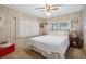 Comfortable bedroom featuring neutral carpet, a ceiling fan, and ample natural light at 703 Corsica Ct, Bradenton, FL 34207