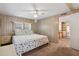 Comfortable bedroom featuring wood paneling, a ceiling fan and a queen-size bed at 703 Corsica Ct, Bradenton, FL 34207