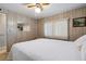 Bedroom with a white bed cover and a lighted ceiling fan at 703 Corsica Ct, Bradenton, FL 34207