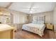 Bright bedroom with neutral walls, a ceiling fan, and a comfortable double bed at 703 Corsica Ct, Bradenton, FL 34207