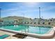 Large outdoor pool with clear blue water, complete with sun loungers and chairs for a relaxing poolside experience at 703 Corsica Ct, Bradenton, FL 34207