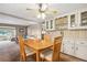 Open dining area featuring a wooden table, easy access to living room, and built-in shelving at 703 Corsica Ct, Bradenton, FL 34207