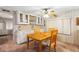 Bright dining area featuring a wooden table, overhead lighting, and classic built-in cabinets at 703 Corsica Ct, Bradenton, FL 34207