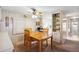Charming dining room with a wooden table, ceiling fan, and built-in shelving at 703 Corsica Ct, Bradenton, FL 34207