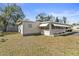 Side view of a home with an attached sunroom offering natural light and additional living space at 703 Corsica Ct, Bradenton, FL 34207