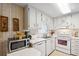Clean kitchen featuring white cabinets, modern microwave, and stainless steel sink at 703 Corsica Ct, Bradenton, FL 34207