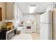 Functional kitchen featuring white appliances, ample cabinet space, and a bright, clean aesthetic at 703 Corsica Ct, Bradenton, FL 34207