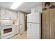 Efficient kitchen with white appliances, cabinets, and tile flooring at 703 Corsica Ct, Bradenton, FL 34207