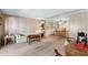 Cozy living room with comfortable seating, wood-paneled walls, and a dining area at 703 Corsica Ct, Bradenton, FL 34207