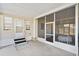 Relaxing screened patio with neutral flooring, ceiling fan, and ample space for entertaining at 703 Corsica Ct, Bradenton, FL 34207