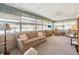 Bright sun room featuring comfortable furnishings and multiple windows at 703 Corsica Ct, Bradenton, FL 34207