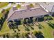 Aerial view of home showcasing a large backyard with tropical landscaping and screened patio at 7661 Summerland Cv, Bradenton, FL 34202