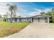 Gray house with double garage and palm trees at 800 Riviera St, Venice, FL 34285