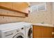 Laundry room with washer, dryer, and cabinets at 8219 Championship Ct, Lakewood Ranch, FL 34202