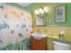 Clean bathroom with sea turtle shower curtain and light wood vanity at 8466 Maureen Ave, North Port, FL 34287