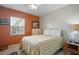 Cozy bedroom with striped bedding and a dresser at 8466 Maureen Ave, North Port, FL 34287