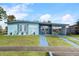 Charming light blue house with a carport and well-manicured lawn at 8466 Maureen Ave, North Port, FL 34287
