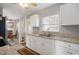 Bright kitchen features granite countertops and white cabinetry at 8466 Maureen Ave, North Port, FL 34287