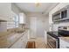 Clean galley style kitchen with white cabinets and granite counters at 8466 Maureen Ave, North Port, FL 34287