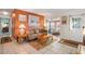 Comfortable living room with orange walls and access to screened porch at 8466 Maureen Ave, North Port, FL 34287