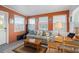 Relaxing sunroom with a sofa, table, and plenty of natural light at 8466 Maureen Ave, North Port, FL 34287