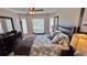 Bright bedroom featuring a king-size bed and plenty of windows at 8773 Stone Harbour Loop, Bradenton, FL 34212