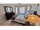 King-size bed in this well-lit bedroom with mirrored dresser at 8773 Stone Harbour Loop, Bradenton, FL 34212