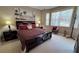 King size bed, dresser, and tropical-themed artwork at 8773 Stone Harbour Loop, Bradenton, FL 34212