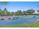 Outdoor cornhole court with benches and landscaped surroundings at 8773 Stone Harbour Loop, Bradenton, FL 34212
