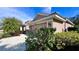 House exterior with garage, landscaping and hibiscus flower at 8773 Stone Harbour Loop, Bradenton, FL 34212