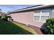 Rear of house with AC unit and some landscaping at 8773 Stone Harbour Loop, Bradenton, FL 34212