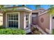 Side view of house entrance with bay window and landscaping at 8773 Stone Harbour Loop, Bradenton, FL 34212