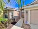 Side view of house entrance, showing walkway and landscaping at 8773 Stone Harbour Loop, Bradenton, FL 34212