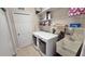 Laundry room with washer, dryer, utility sink, and shelving at 8773 Stone Harbour Loop, Bradenton, FL 34212