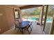 Patio with table and chairs, overlooking the pool and fenced backyard at 8773 Stone Harbour Loop, Bradenton, FL 34212