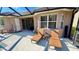 Spacious patio adjacent to the pool with comfortable lounge chairs at 8773 Stone Harbour Loop, Bradenton, FL 34212