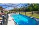 Relaxing screened-in pool and spa with tiled accents at 8773 Stone Harbour Loop, Bradenton, FL 34212